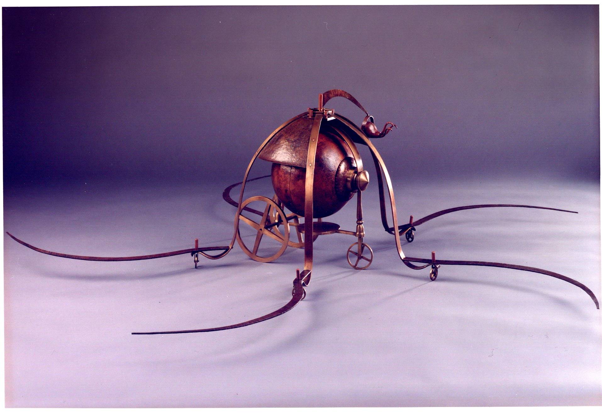 cast bronze sphere with spider scythe legs